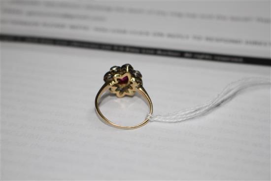 A yellow and white metal, ruby and diamond set oval cluster ring, (adapted),